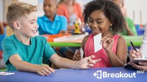 Two kids sitting at a table with index cards brainstorming games in Breakout EDU.