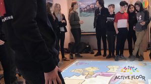 Teacher and students surrounding the ActiveFloor, ready to engage and interact with its games.